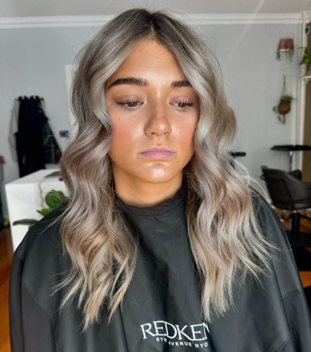 Medium-length soft waves with silvery-blonde color for a fresh school look