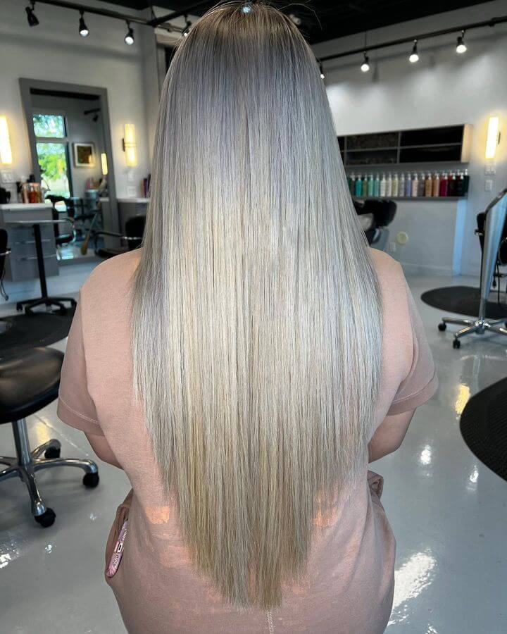 Silver ombré balayage on a layered V-cut for a trendy look.