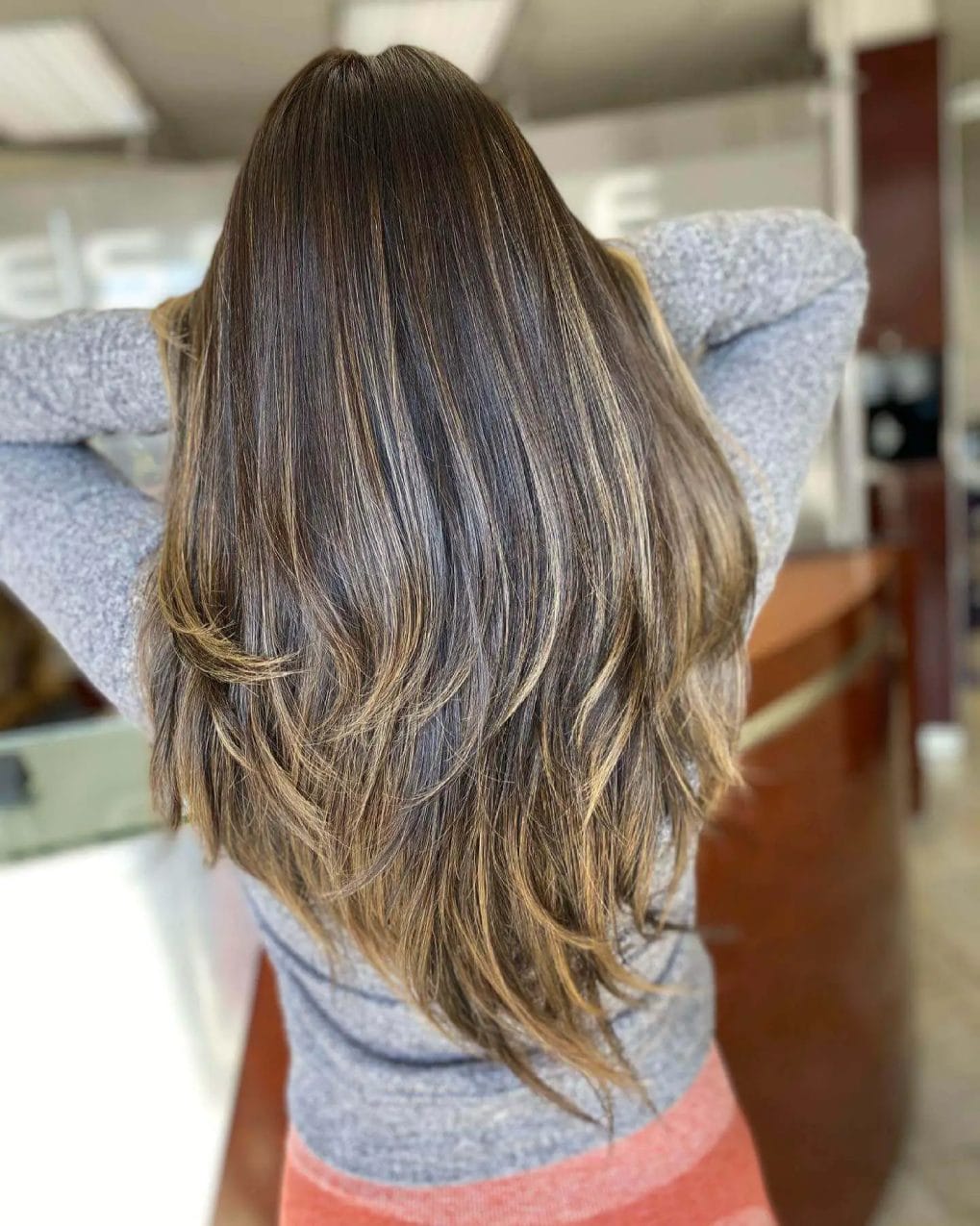 Soft blowout hairstyle with base bump balayage and V-cut layers.