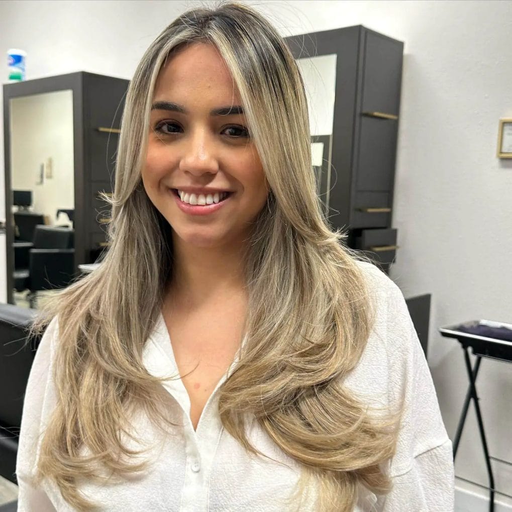 Refreshed blond balayage with 90's bombshell layers on thick hair.