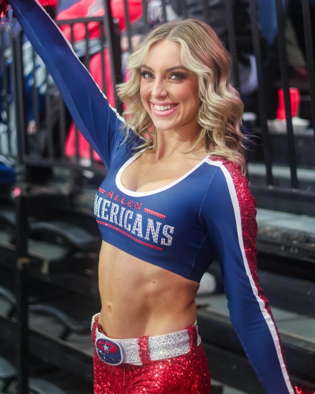 Blonde cheerleader with voluminous curls and side part