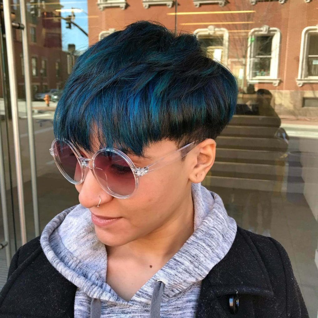 Dynamic mushroom cut with textured layers and electric blue highlights.