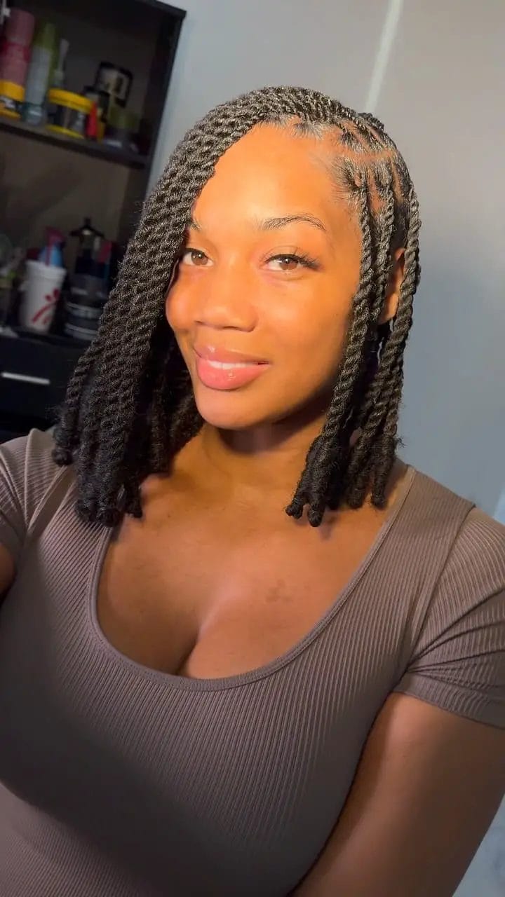 Halfway styled kinky twists into a bob with deep side part and wavy ends