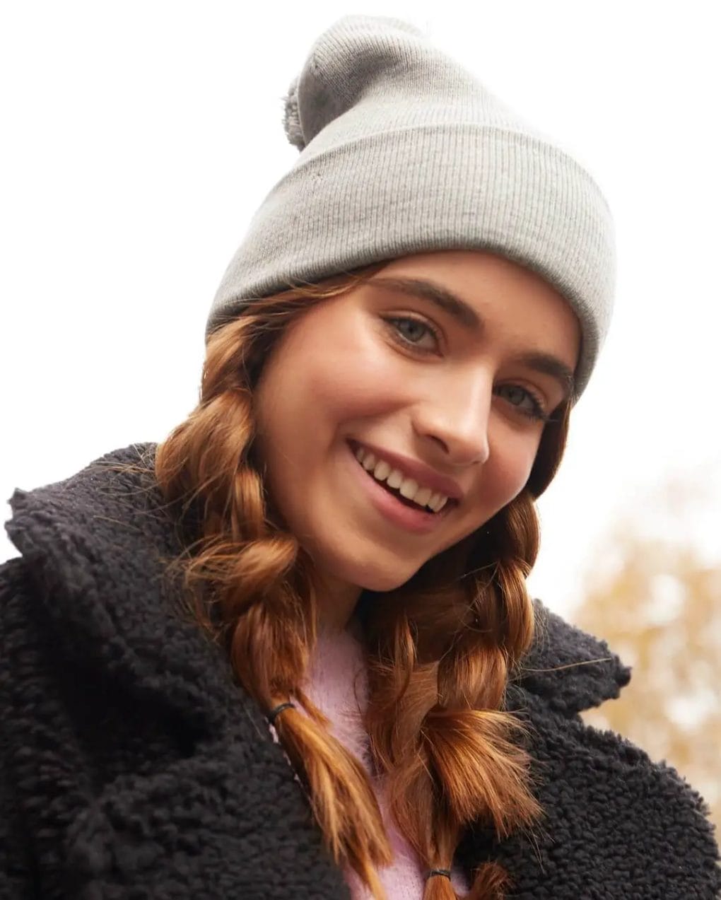 Honey-toned rope braids under a cool grey beanie for a bohemian vibe.