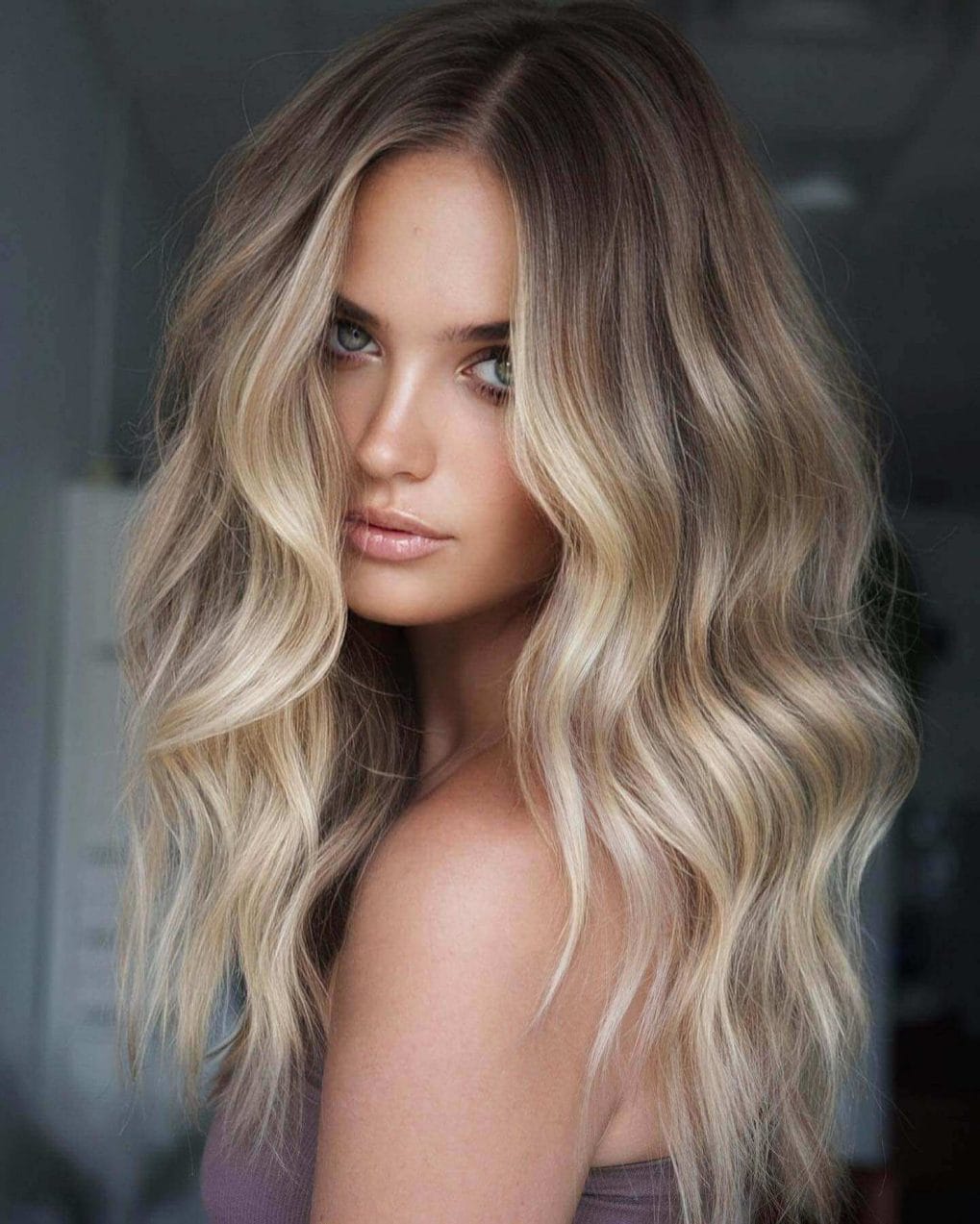 Medium-length boho waves with light blonde face highlights