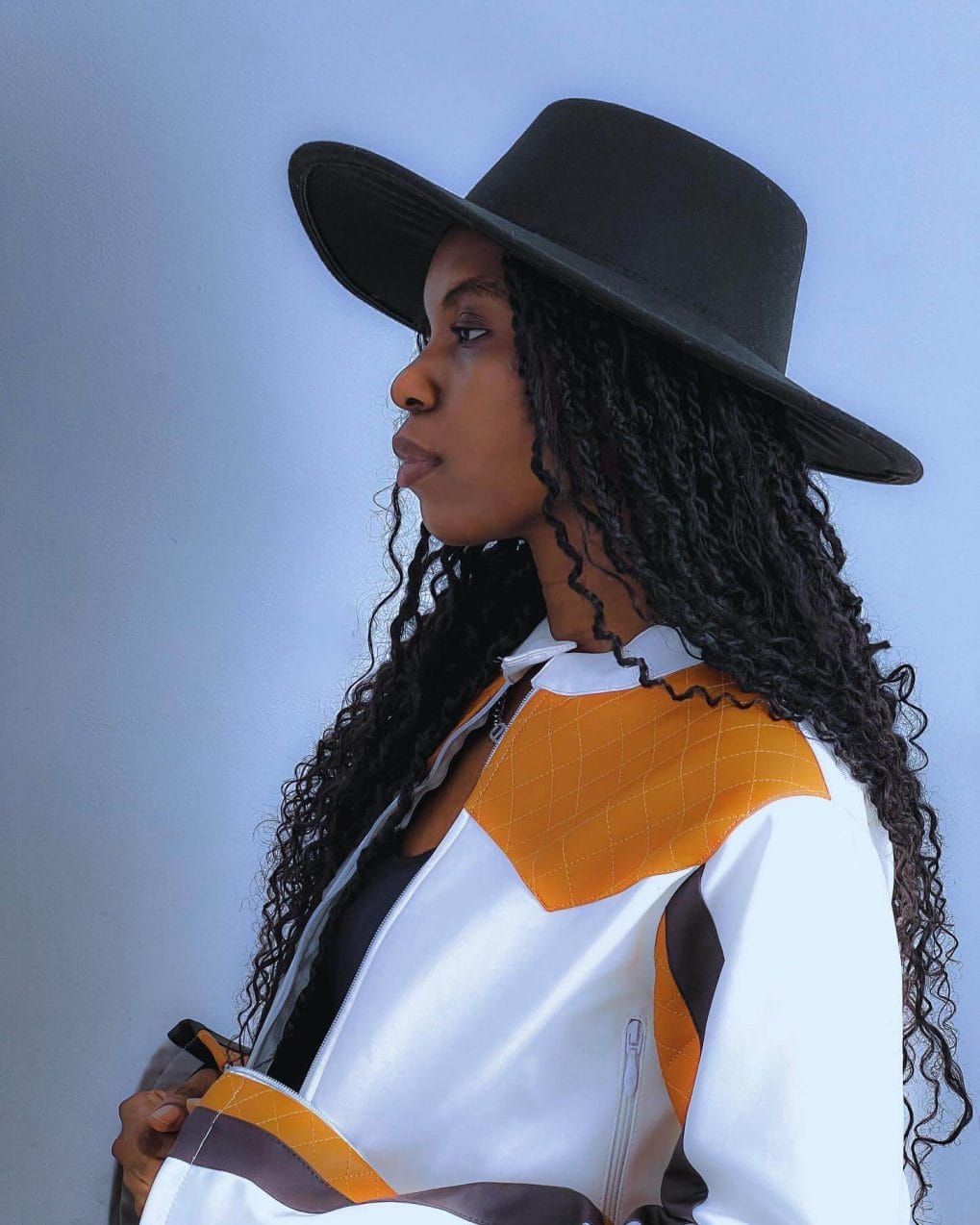 Twist-outs under a hat for a Western-meets-boho flair