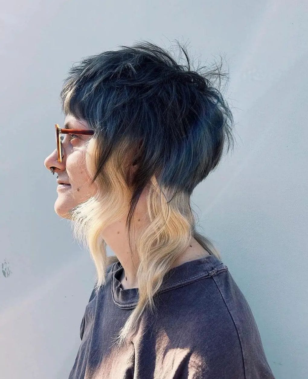 Rebellious jellyfish haircut featuring a dark to light color gradient from mysterious blues to creamy blondes.