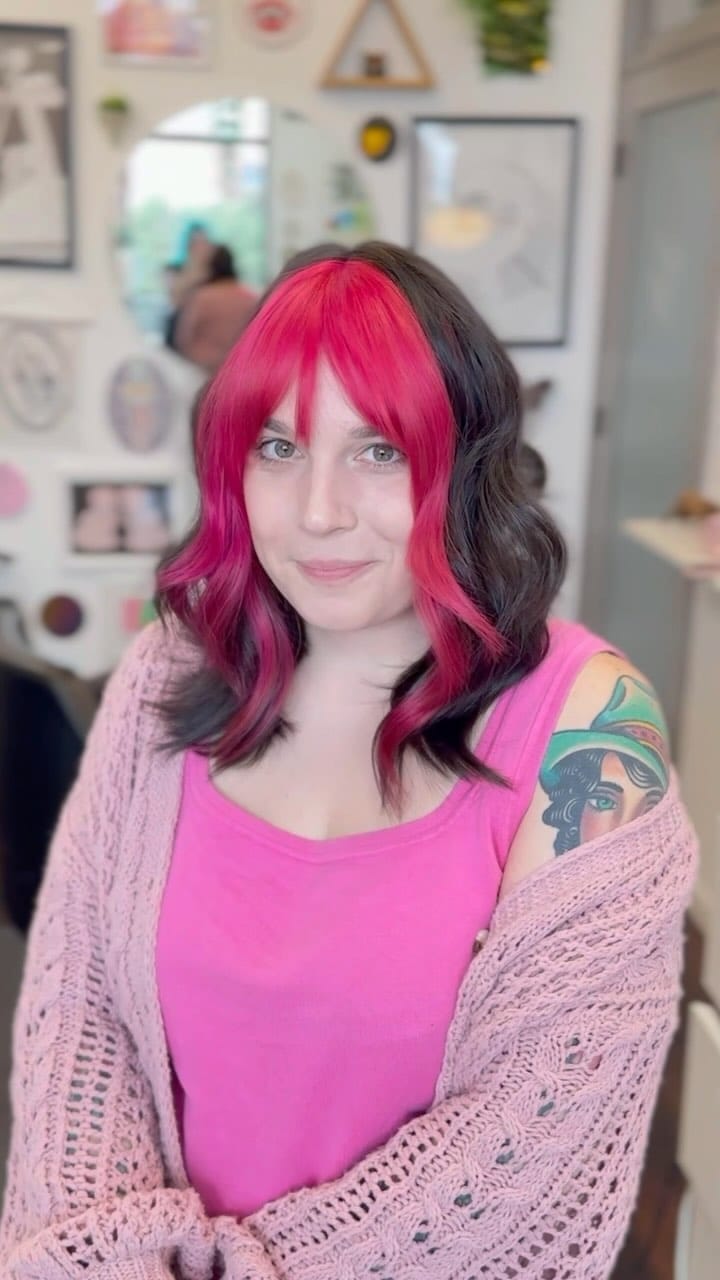 Medium-length curls with bold pink face highlight