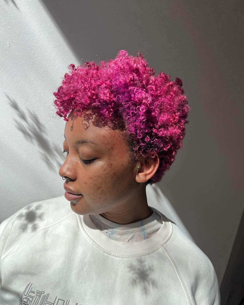 Bold pink short curls for a refreshing, low-maintenance summer