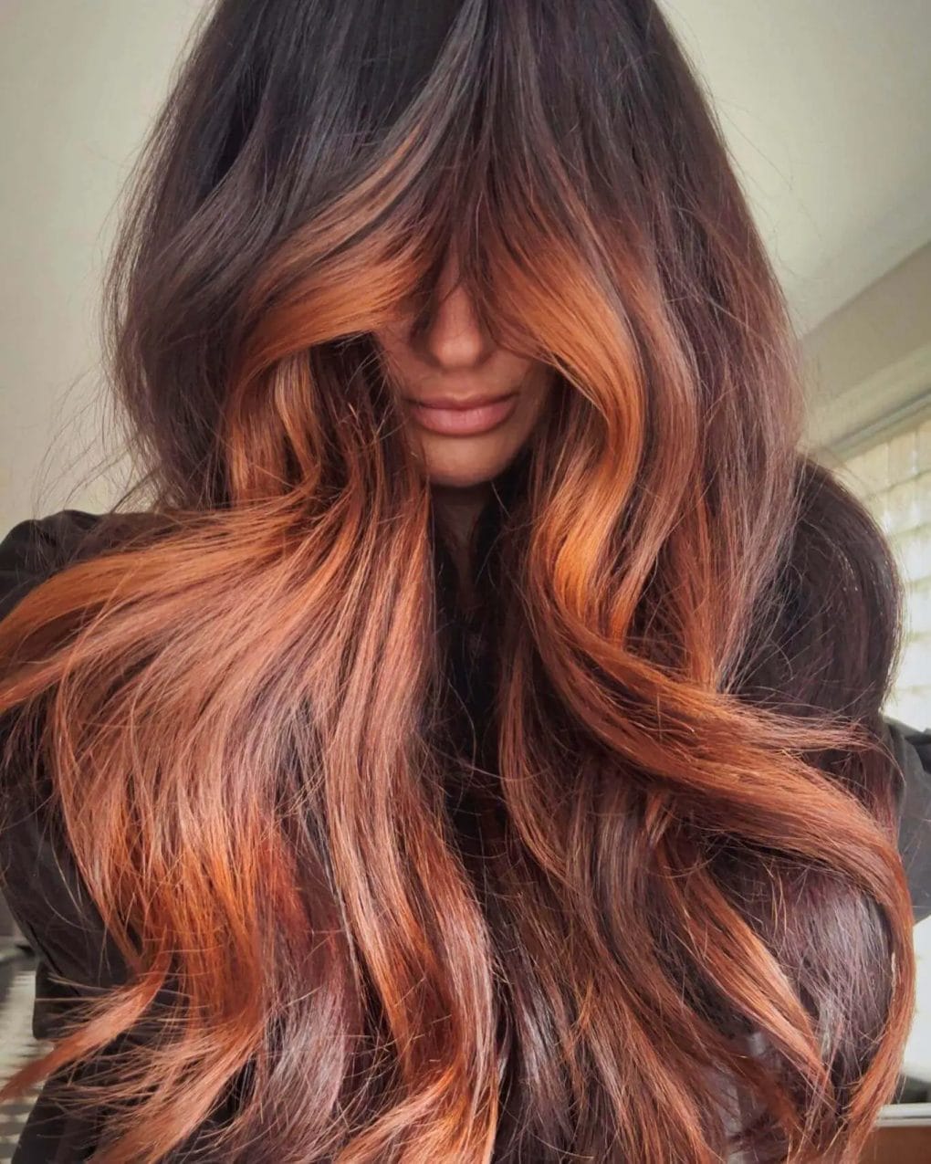 Bold shadow root with vibrant copper waves and flowing layers.