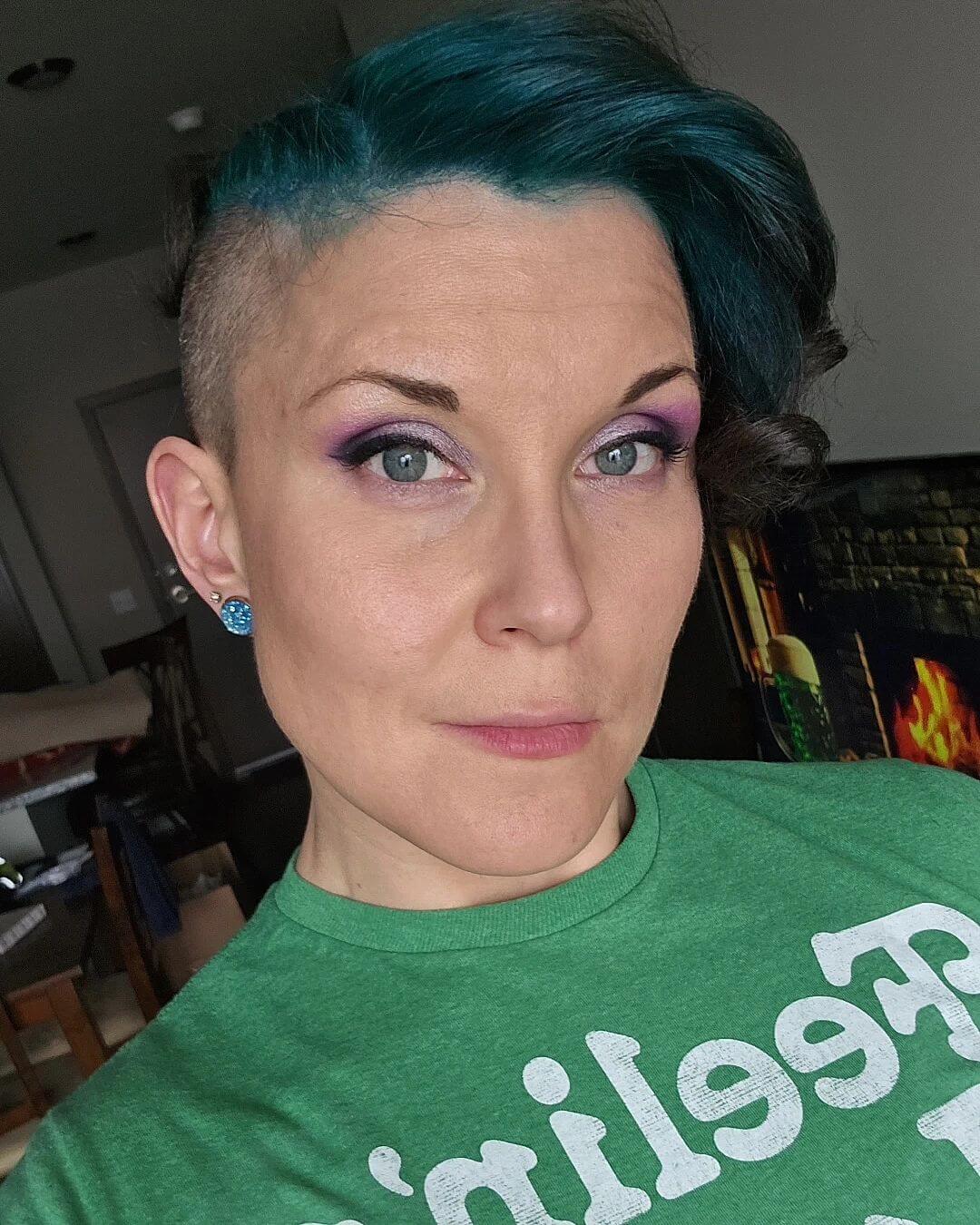 Asymmetrical style with bold teal color and shaved side