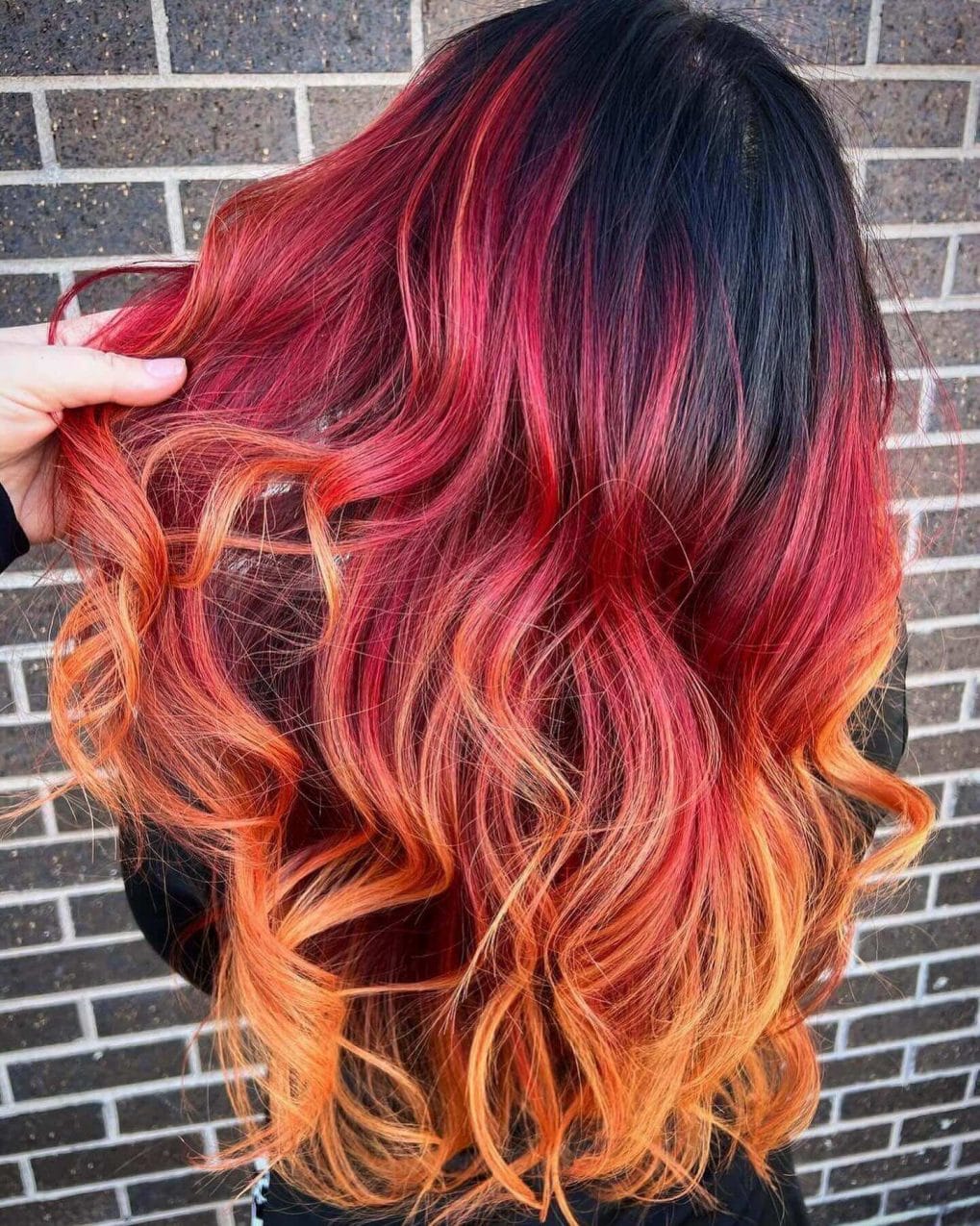 Warm red and orange wavy hair evoking a late-summer bonfire