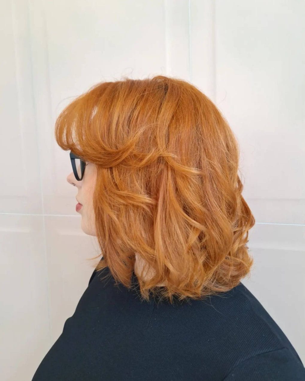Bouncy copper bob with side-swept bangs