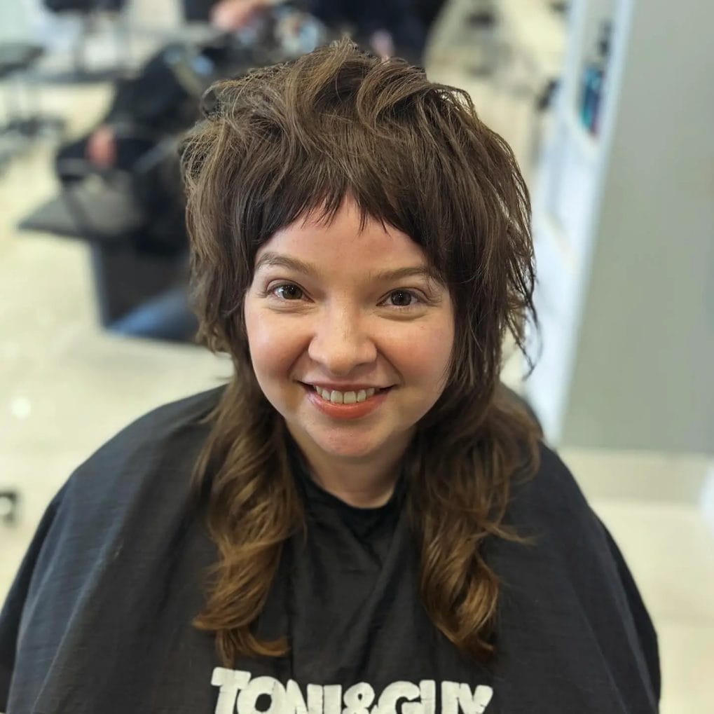 Fun, bouncy curled mullet with light wispy fringe and playful waves