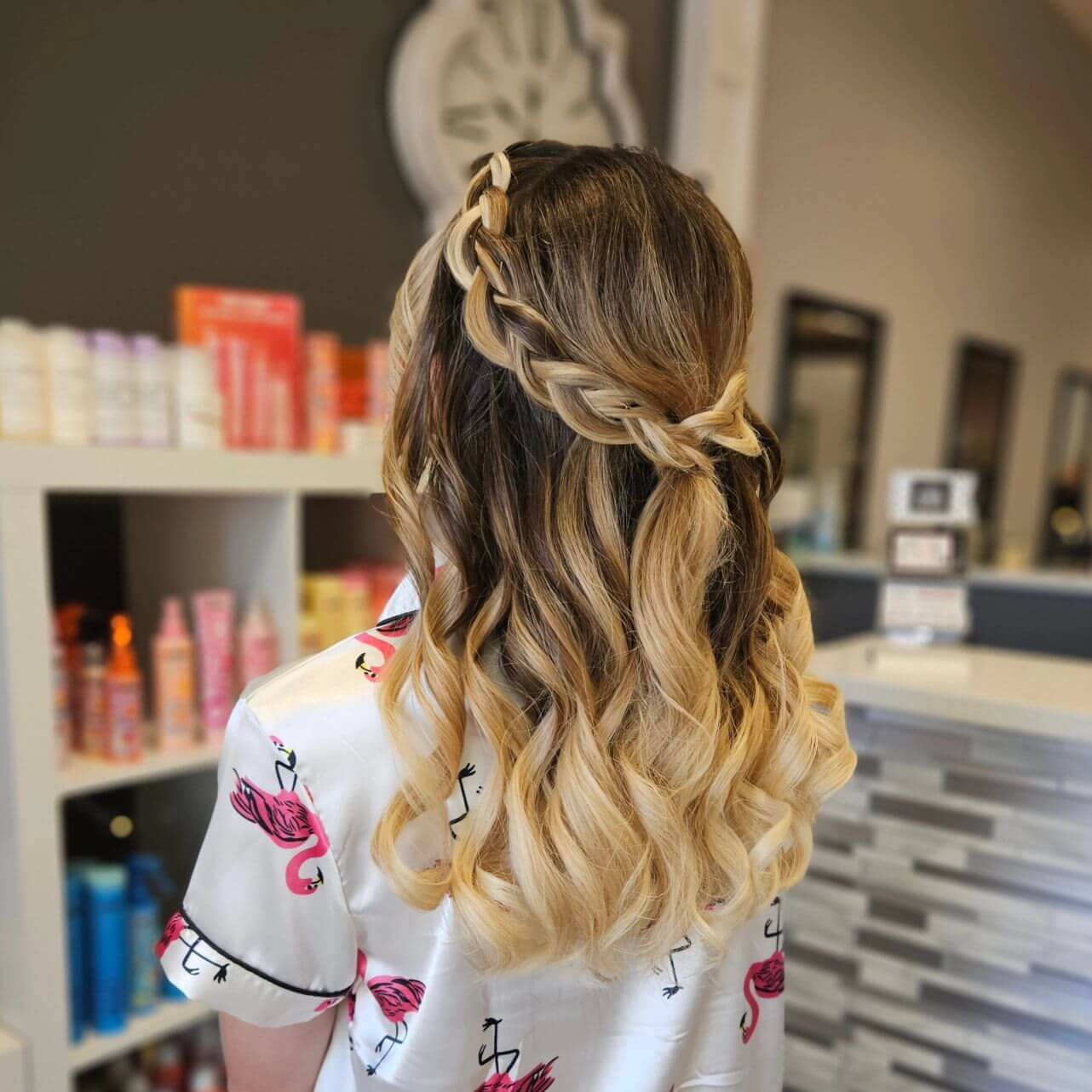 Braided crown with loose blonde curls for prom