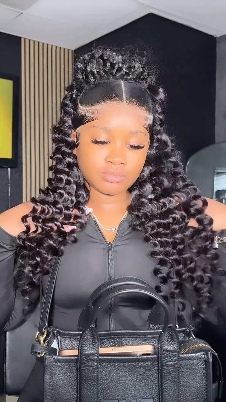 Bouncy curls under a braided crown with soft front