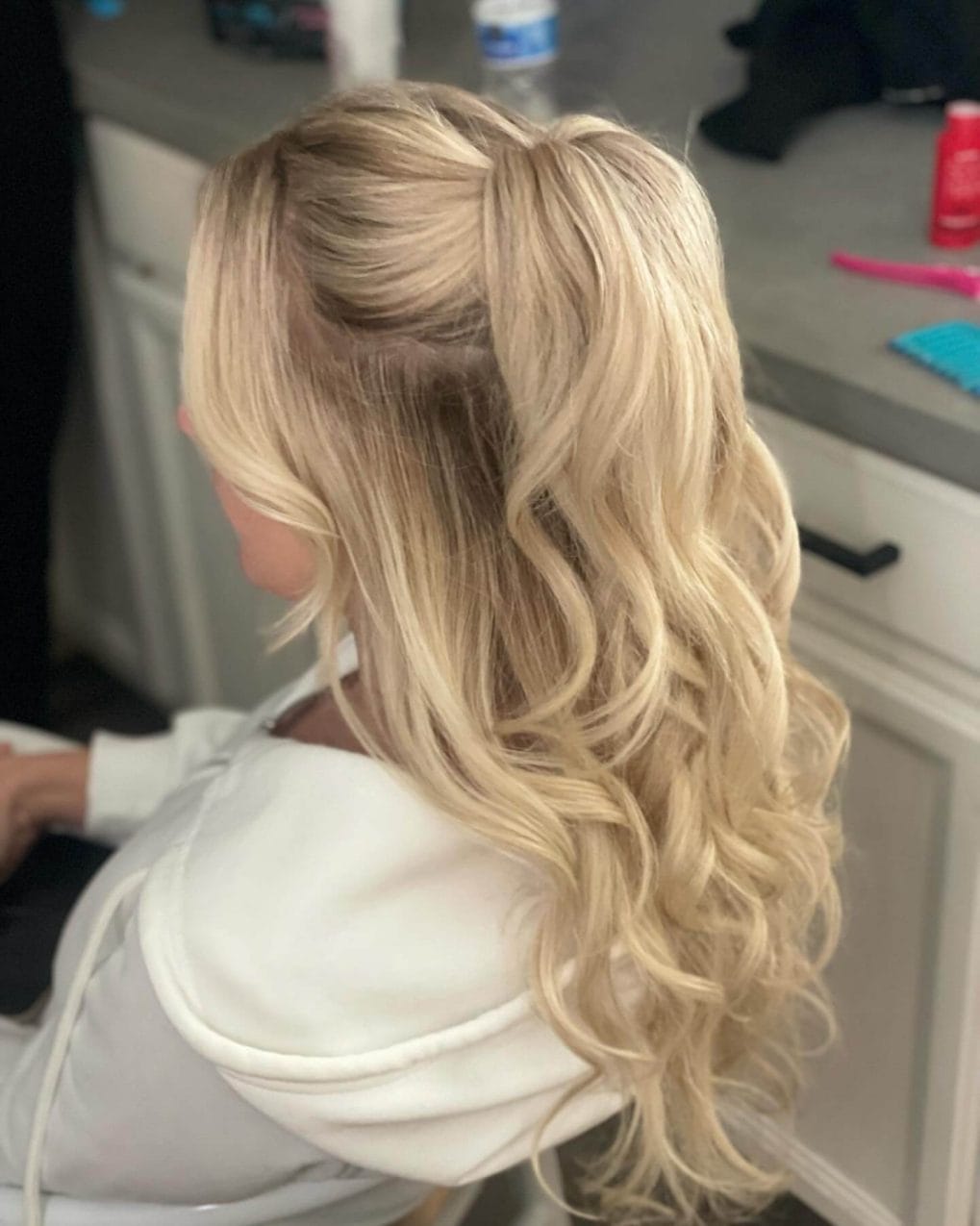 Bright blonde curls with sleek top for prom