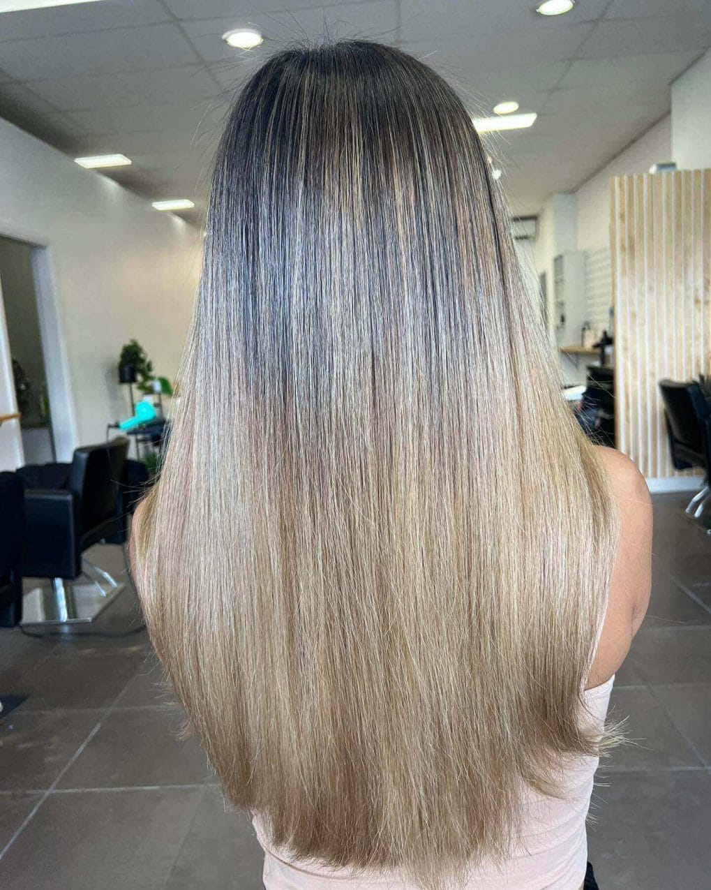 Ash to light wheat blonde gradient balayage in long straight hair.