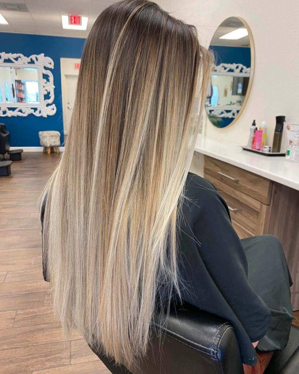 Brunette roots blending to sun-kissed blonde balayage on straight hair.