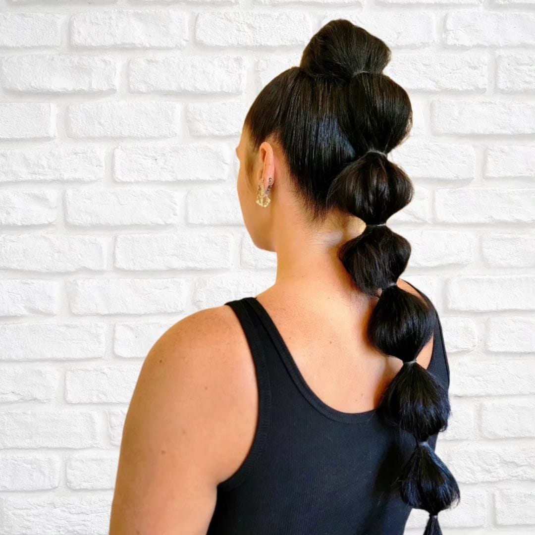 Sleek bubble ponytail for a volleyball-ready playful and polished hairstyle