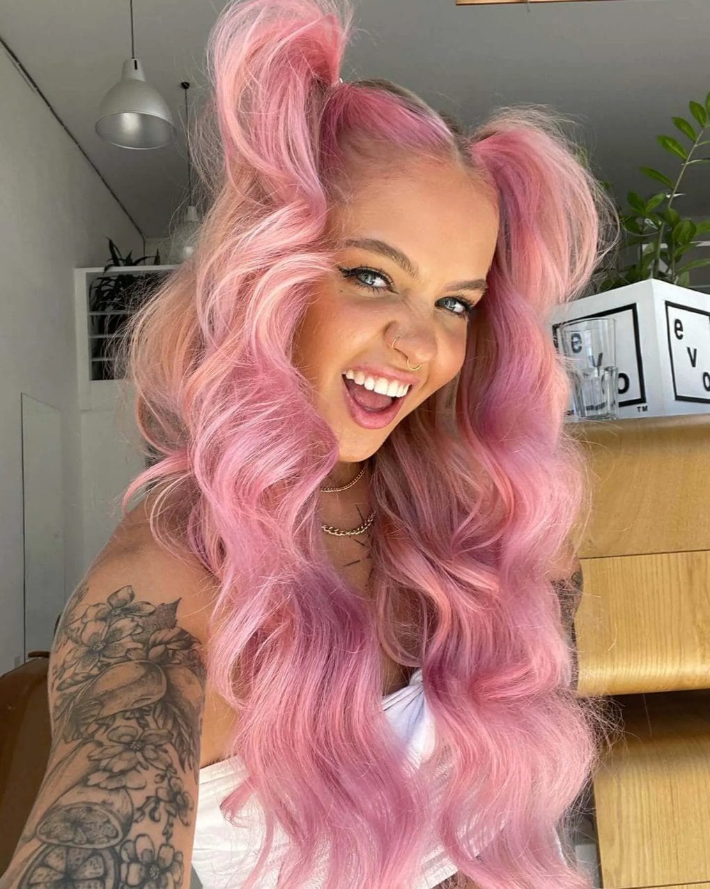Playful bubblegum pink waves with twin top knots, embodying the carefree energy of festival fashion.