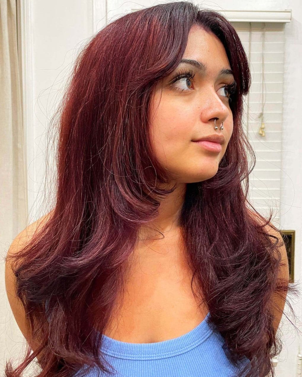 Burgundy layers with 90s curtain bangs trendy