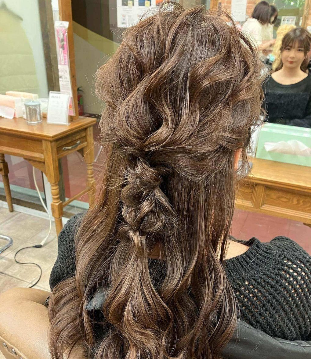 Caramel-toned braid flows into a full, textured hairstyle