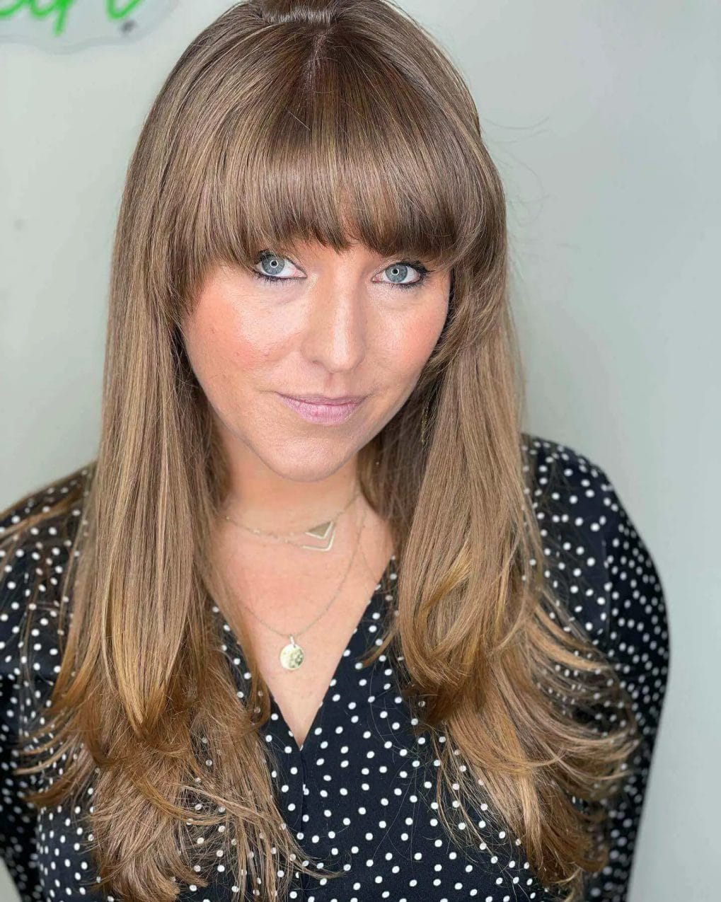 Timeless caramel tresses with straight-across bangs.