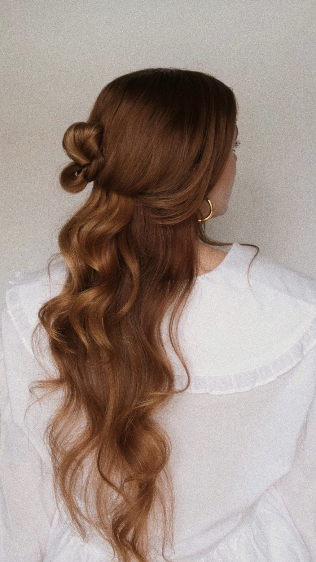 Romantic half up half down style with warm caramel waves