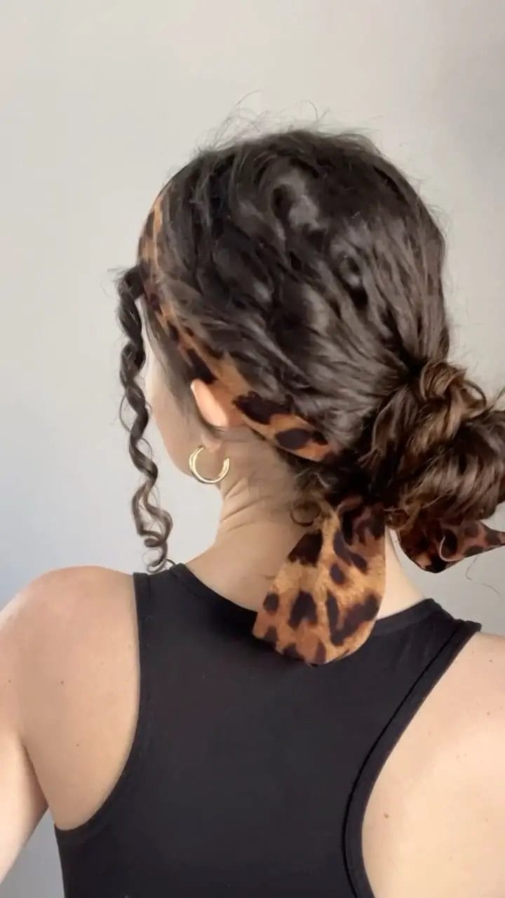 Casual textured low bun with patterned scarf for summer evenings
