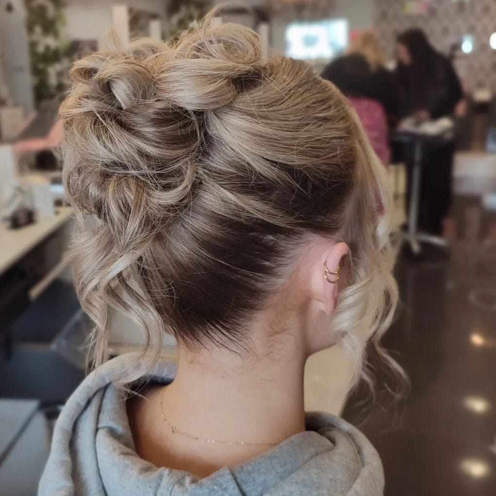 Messy casual high bun with soft face-framing strands