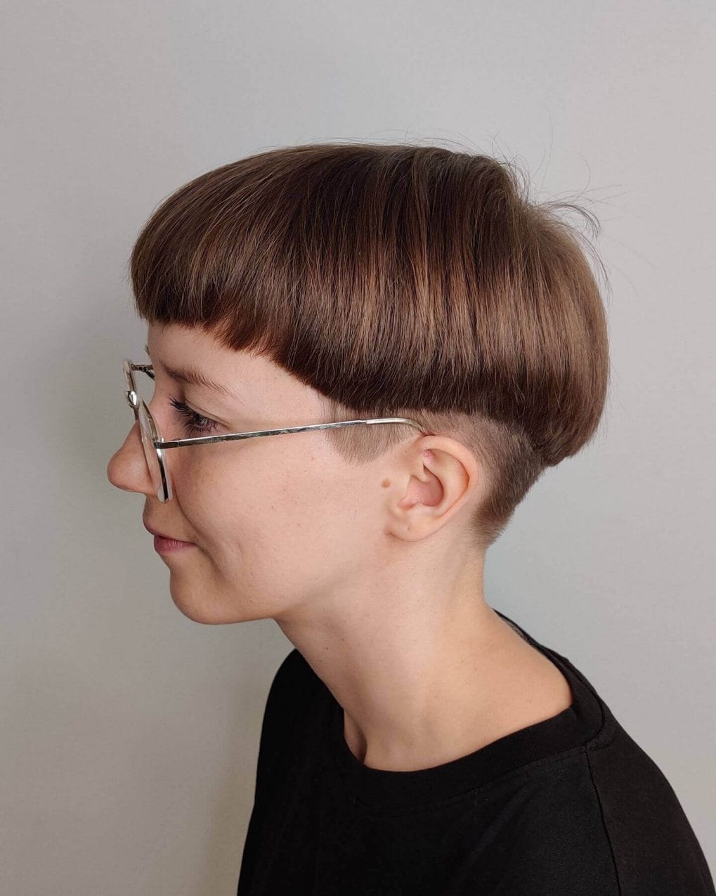 Pristine mushroom cut with straight fringe in lustrous chestnut shade.