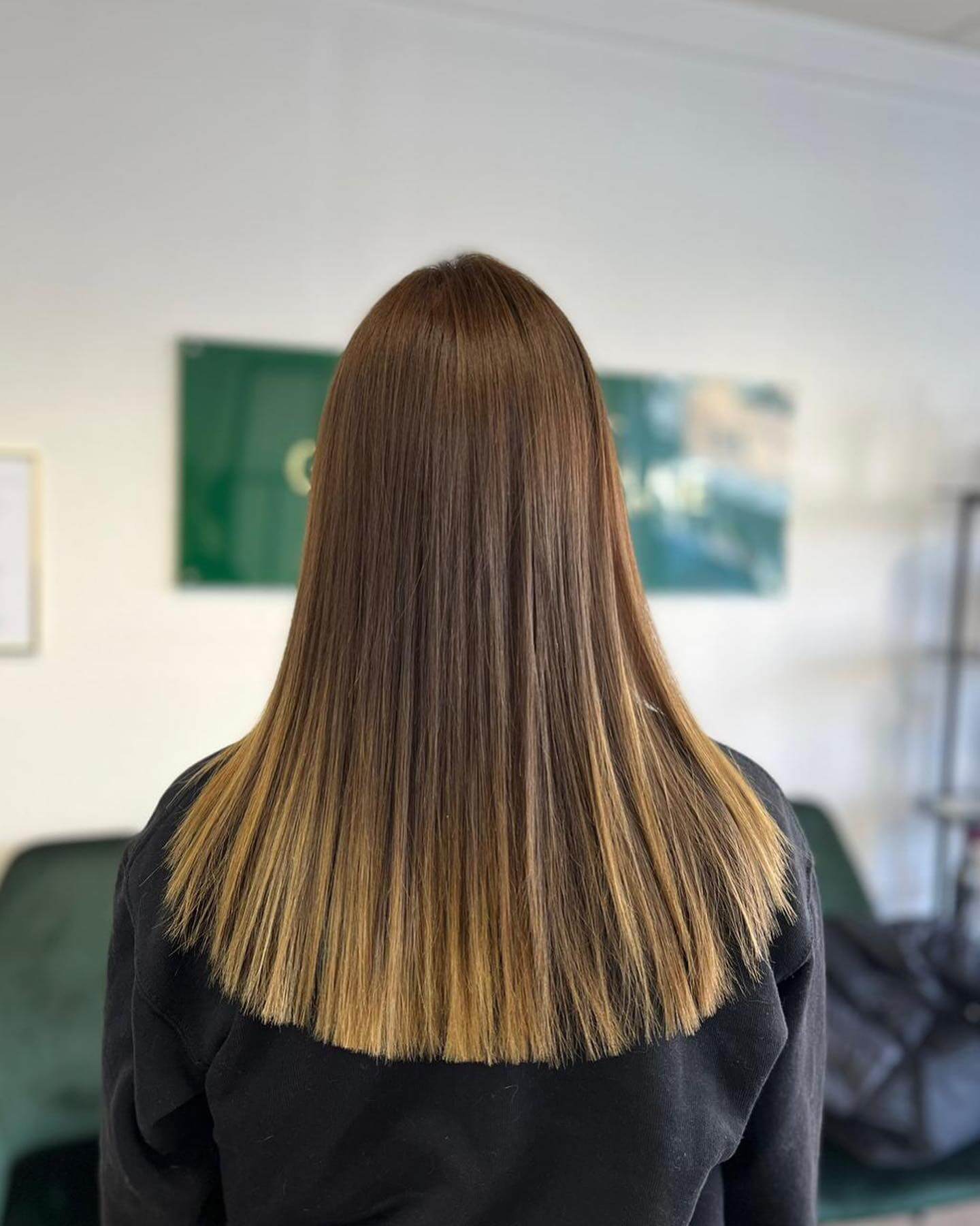 Rich chestnut to honey-blonde ombre U-shaped haircut with precise alignment.