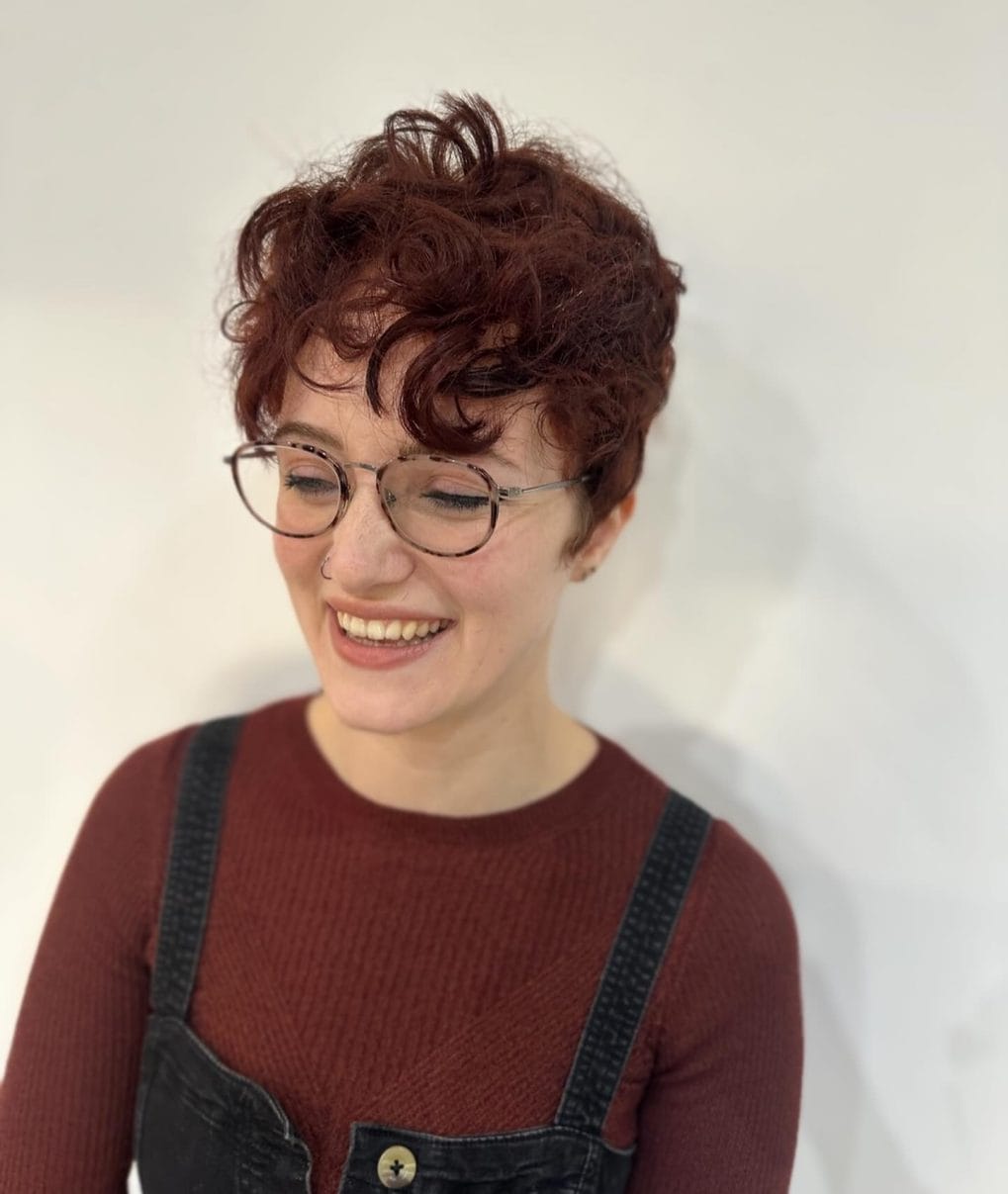 Lively curly pixie in rich auburn with chic and easy manageability