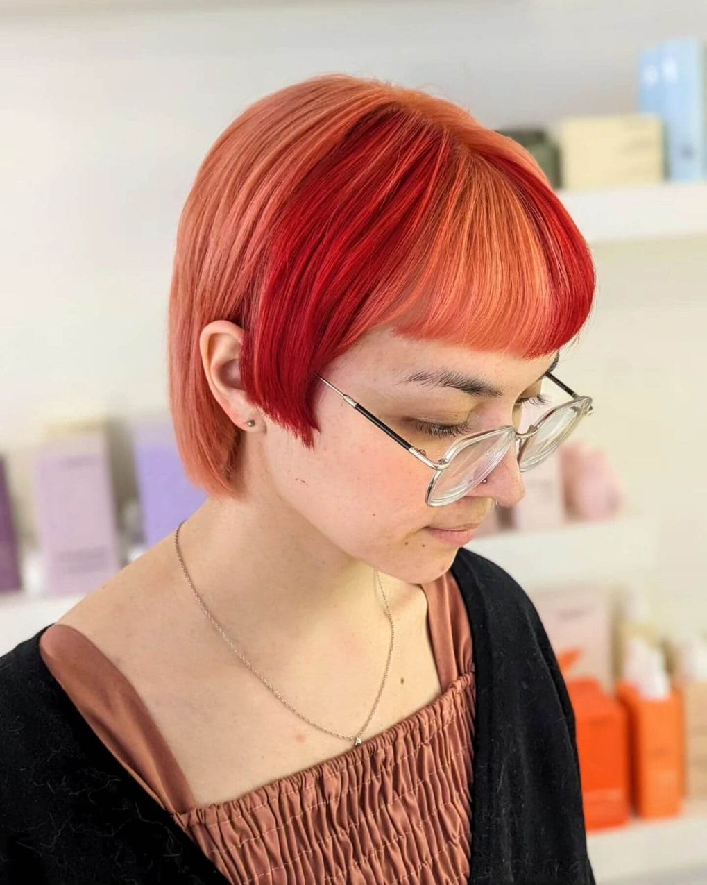 Bold copper-red straight cut with neat bangs for summer