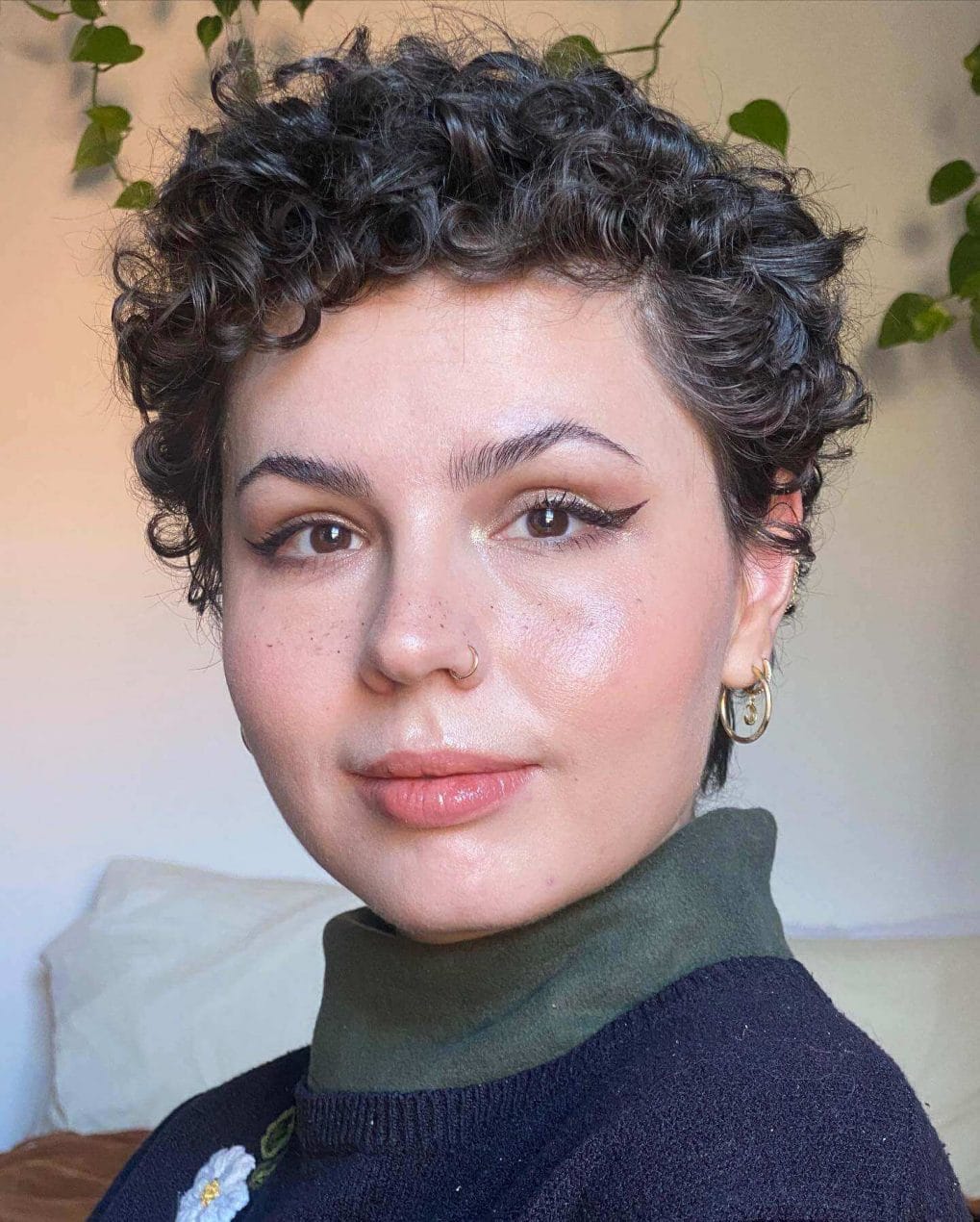 Chic cropped curly pixie with asymmetrical twist.