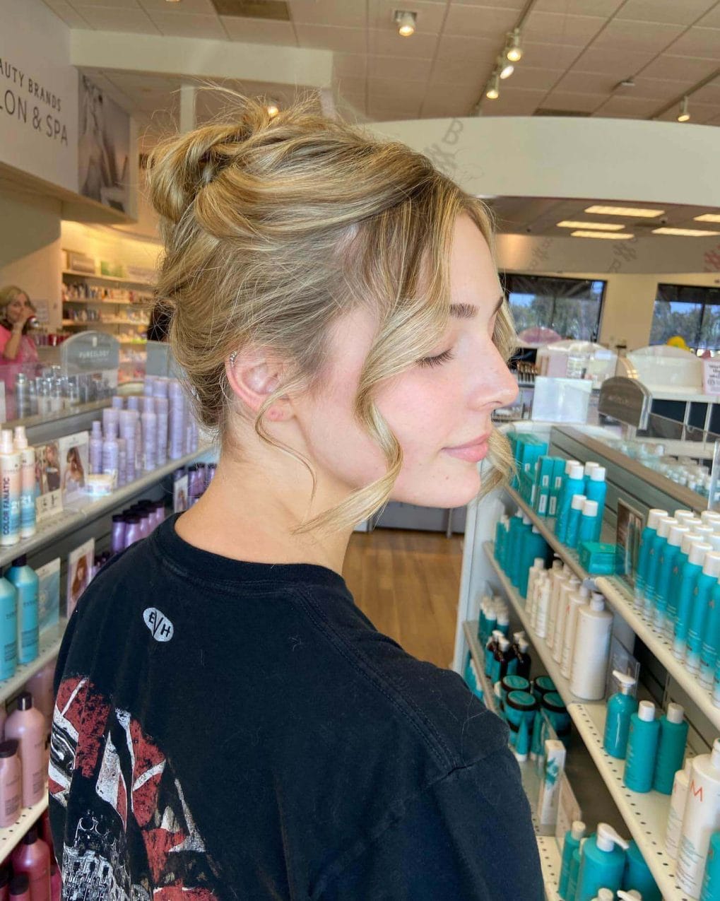Chic high blonde bun with relaxed wavy strands