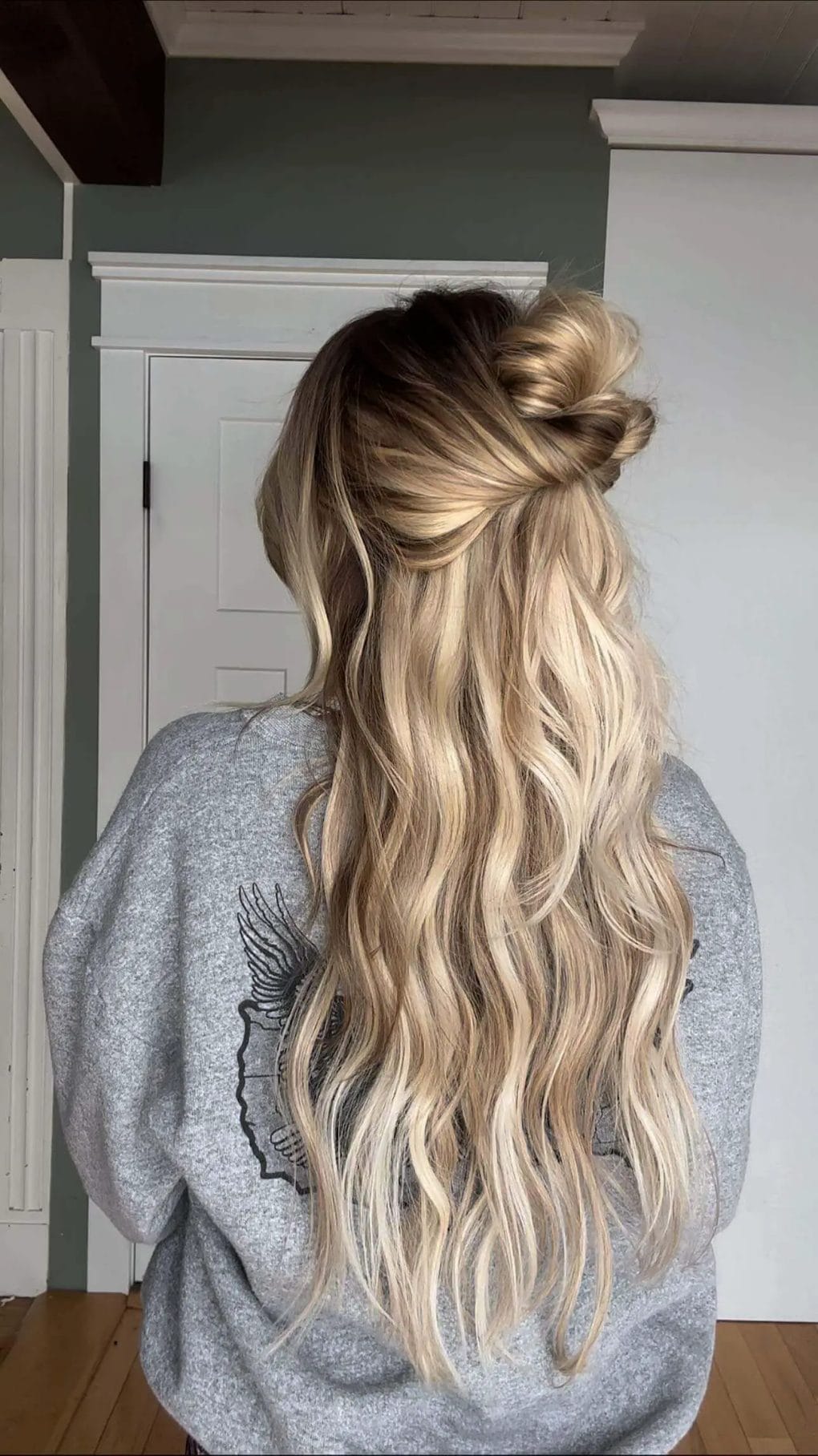 Elegant top knot twist with full waves for a balanced birthday hairstyle.