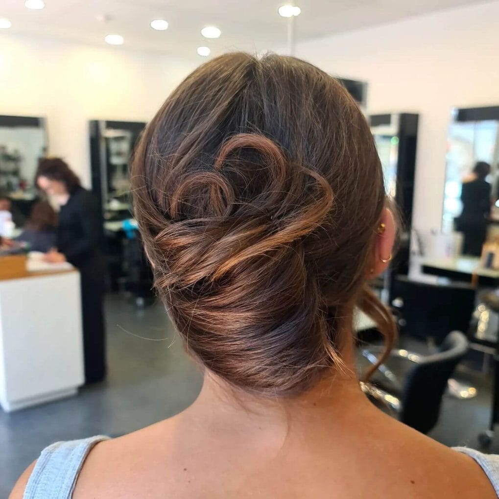 Chic twisted bun with soft romantic loops.