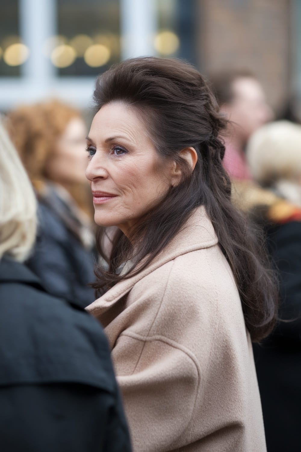 A woman wearing a chic half-up half-down hairstyle, looking elegant and stylish.