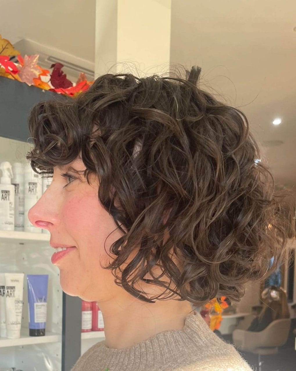 Chin-length bob with sculpted curls and subtle highlights.