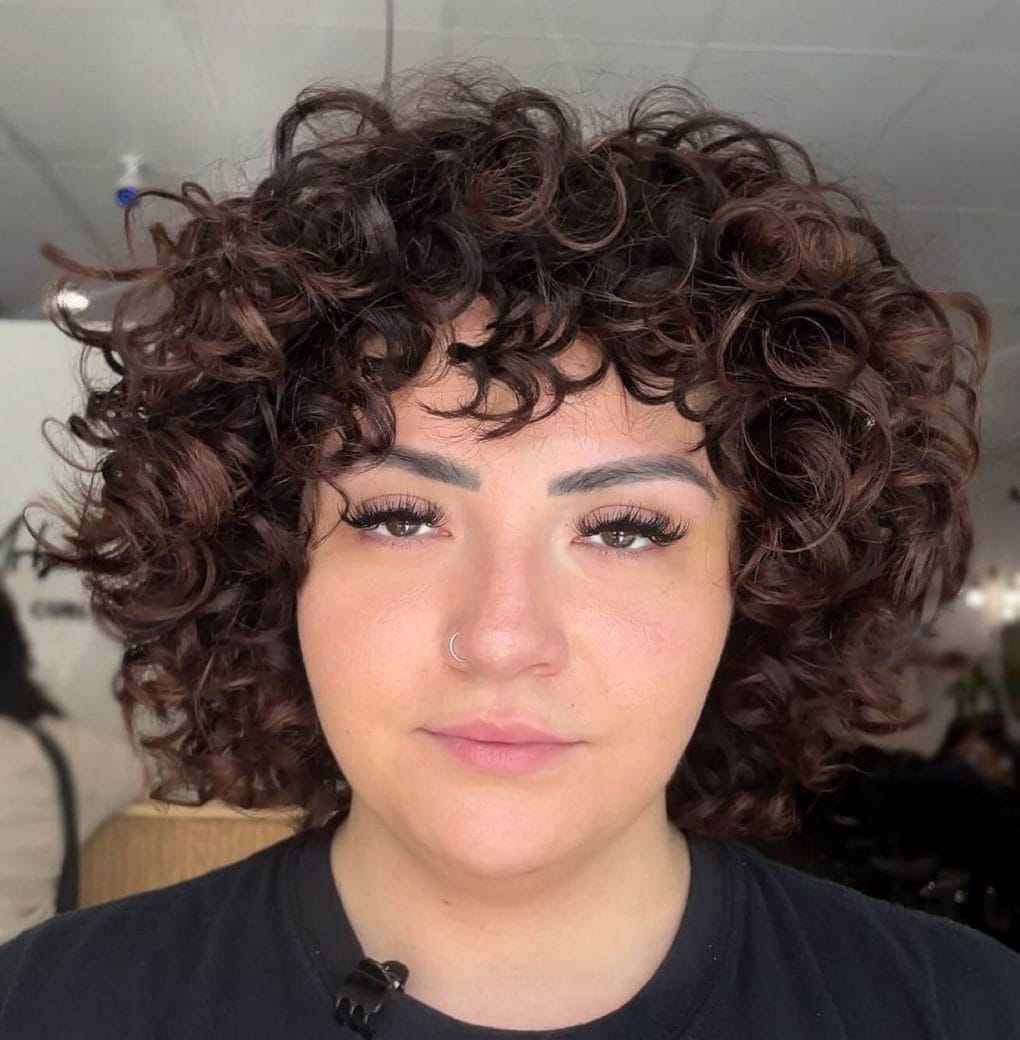 Chocolate-colored short hair with tight, cascading ringlets.
