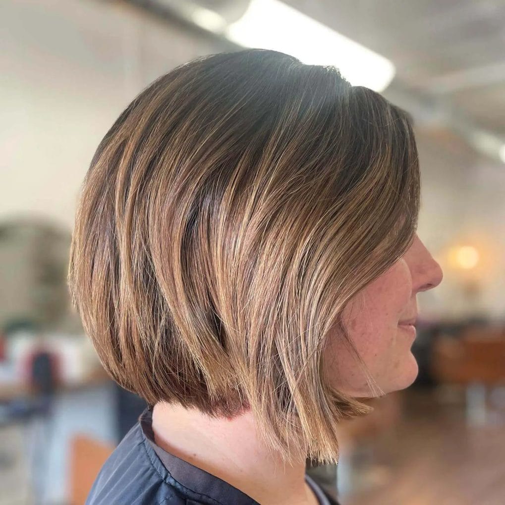 Chocolate and honey blended bob with a natural flow and side-swept bangs.