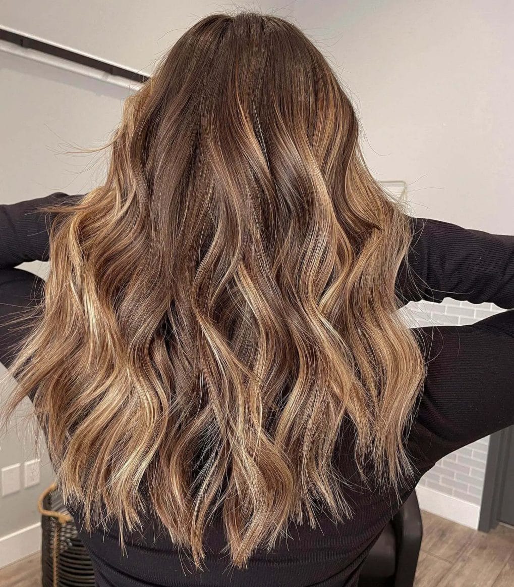 Rich chocolate to honey-blonde balayage with soft layers, reminiscent of a winter sunset.