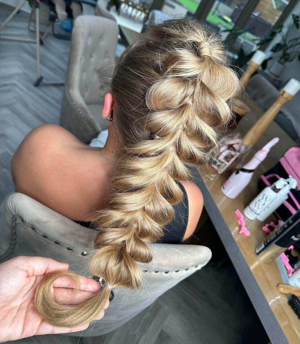 Chunky pull-through braid with blonde highlights for a sporty voluminous look
