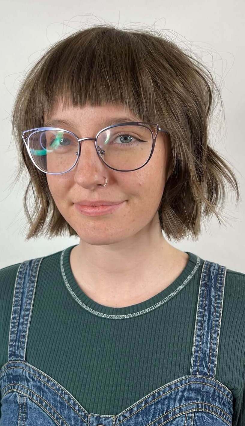 Classic shaggy bob with straight-across bangs and natural brown tones