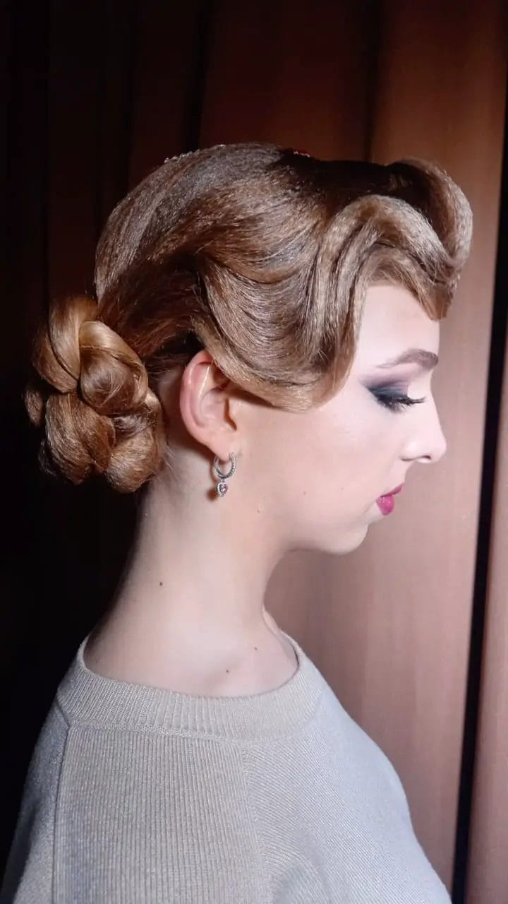 Glamorous waved top flowing into a classic bun