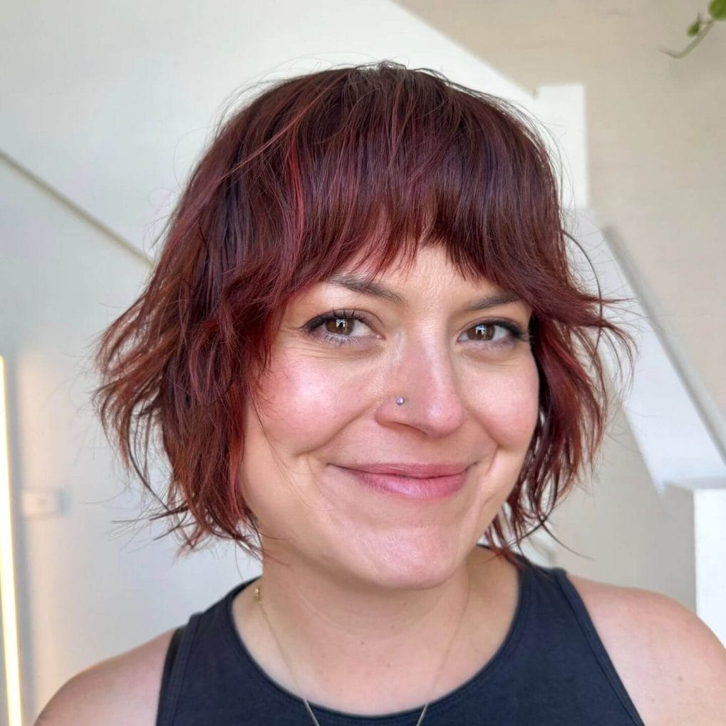 Copper balayage shaggy bob with relaxed feel and messy bangs