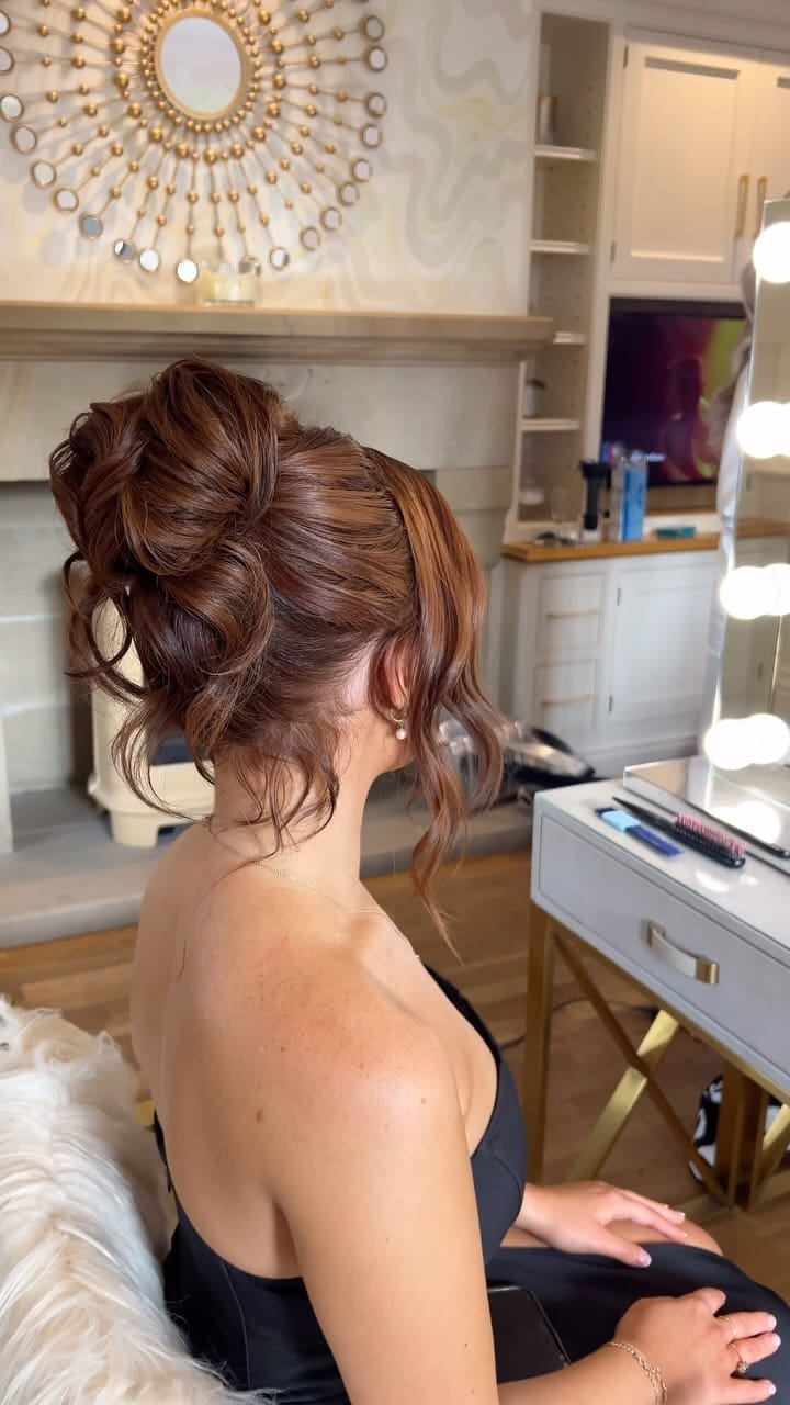 Coppery high bun with gentle wispy frame