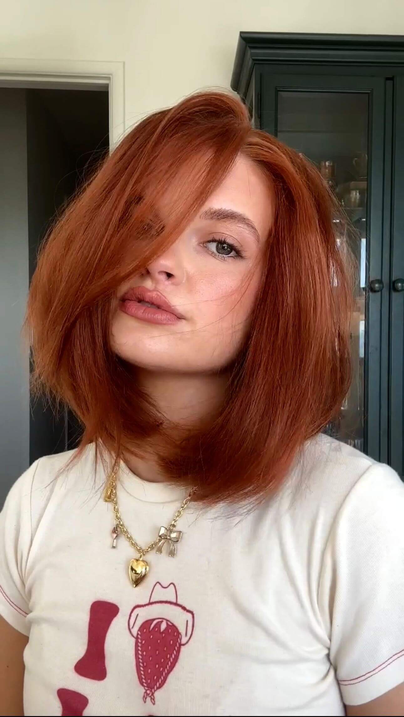 Shoulder-length copper '90s bob with playful waves, subtle layers, and a side part